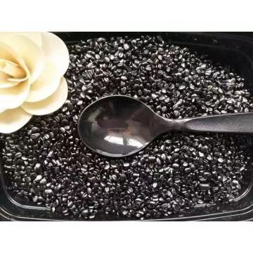 Black masterbatch pellets on a tray